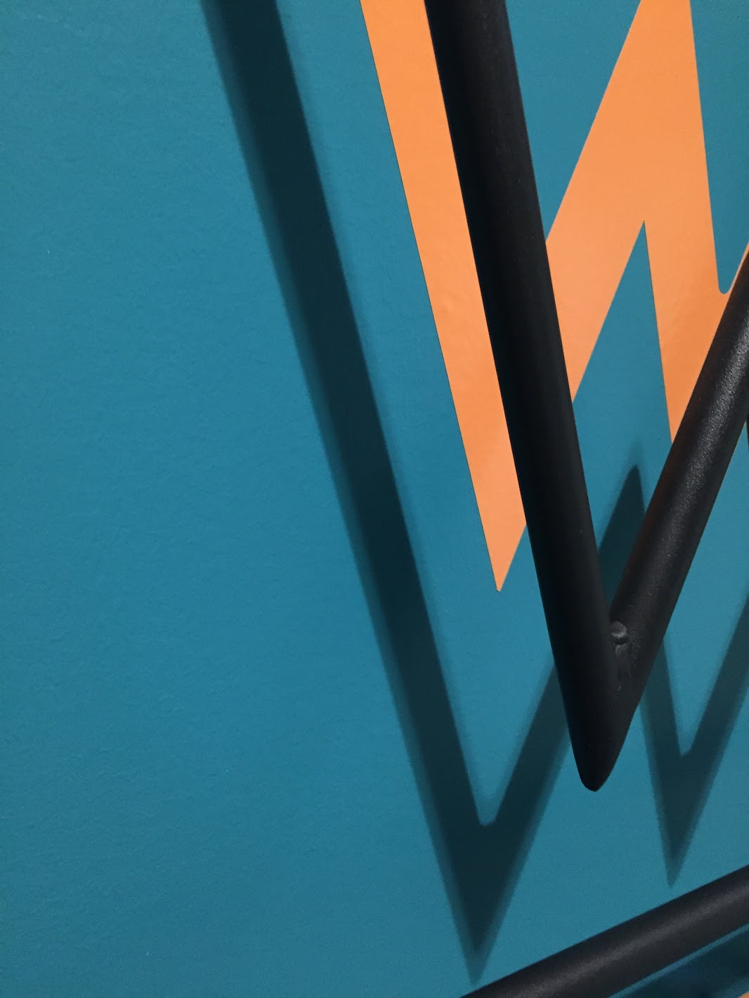 Teal Wall with Orange W Graphics